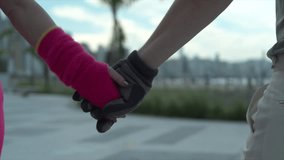 Slow motion close up on hands of a young urban couple with gloves that are walking and holding hands in an urban environment - Powered by Shutterstock - Get 15% off with code: PIKWIZARD15