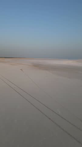 4K Aerial shot of salt flats at rann of Kutch during sunrise. White desert of Kutch in Gujarat, India. Aerial view over the expansive salt marsh of The Great Rann of Kutch. Tranquil Nature landscape.