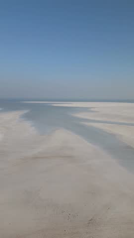 4K Aerial shot of salt flats at rann of Kutch during sunrise. White desert of Kutch in Gujarat, India. Aerial view over the expansive salt marsh of The Great Rann of Kutch. Tranquil Nature landscape.
