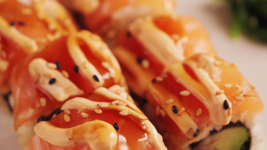 Fresh Japanese sushi and rolls with salmon and Philadelphia cheese. Traditional Asian cuisine with seafood. High quality 4k footage