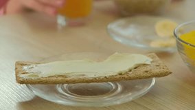 Close up of woman hand pouring sliced cucumber on crispy bread with cheese. The importance of healthy breakfast, snack and ease of meal preparation. - Powered by Shutterstock - Get 15% off with code: PIKWIZARD15