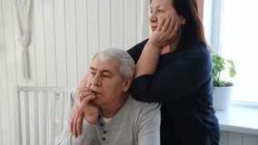 Old couple have breakfast sitting at the kitchen table, drink coffee. Embracing elderly man and woman. Senior couple together marriage in retirement talking with each other. Enjoying the pleasantries - Powered by Shutterstock - Get 15% off with code: PIKWIZARD15