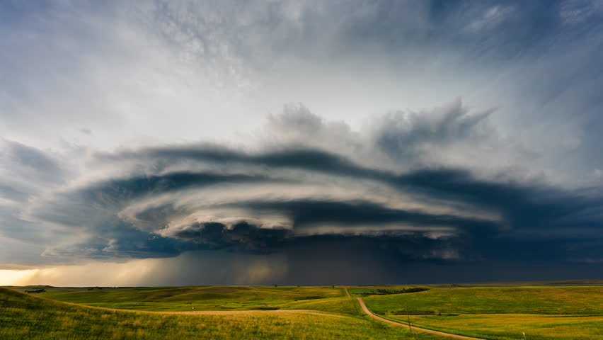 Powerful storm clouds churn across the wide sky as severe weather approaches, showcasing dramatic motion, dark formations, and the intense energy of a looming atmospheric event