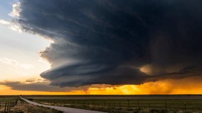 A powerful supercell thunderstorm showcases nature’s force with dangerous weather and vivid lightning, all set against a colorful sunset that highlights the storm’s dramatic structure - Powered by Shutterstock - Get 15% off with code: PIKWIZARD15