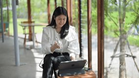 woman is sitting at a table with a laptop in front of her. She is smiling and she is enjoying her time - Powered by Shutterstock - Get 15% off with code: PIKWIZARD15