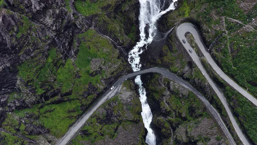 Famous Trollstigen road twists through Norway mountains with scenic Stigfossen waterfall in view