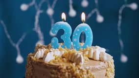 Close-up slow-motion of a birthday cake with number 30 candles blowing out on a blue background, symbolizing milestone birthday celebration, happiness, and festive moments. Perfect for parties, events - Powered by Shutterstock - Get 15% off with code: PIKWIZARD15