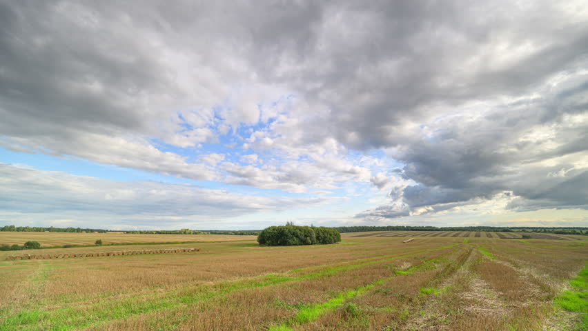 A Beautiful Scenic Agricultural Landscape Set Beneath a Dramatic, Cloudy Sky Above