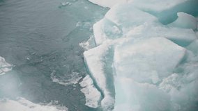 Shifting fragments of sea ice breaking apart along frigid ocean currents, revealing cracked turquoise slabs, water, and jagged edges in a dynamic polar melt and freeze phase. - Powered by Shutterstock - Get 15% off with code: PIKWIZARD15
