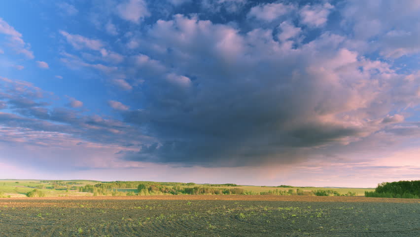 Dramatic Cloud Formation Over an Agricultural Landscape with Stunning Visual Elements Time lapse.