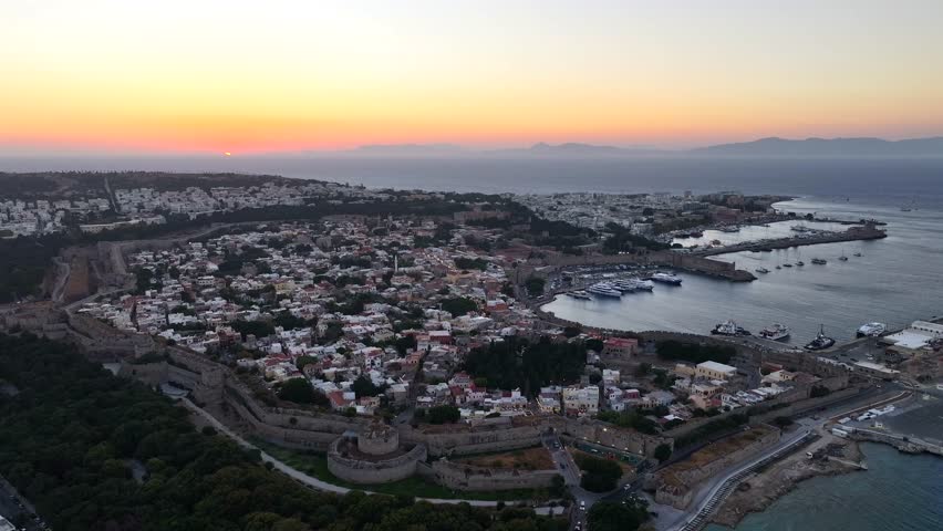 Rhodes Town in Greece, a vibrant mix of medieval old town and modern city life, with stone walls, narrow streets, beaches, and lively Mediterranean culture.
