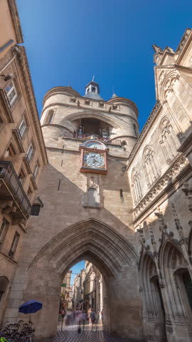 Porte Saint Eloi timelapse hyperlapse, also called Grosse Cloche, is a medieval gothic gate in Bordeaux, France. A symbol of the city's history with a big bell and clock. Blue sky enhances its beauty