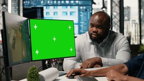 Real estate colleagues evaluates blueprints next to chroma key screen, zoning regulations and property investment opportunity for housing and residential area market growth. Camera B. - Powered by Shutterstock - Get 15% off with code: PIKWIZARD15