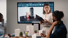 Female real estate contractor presenting structural blueprints and 3D models, engage in a meeting to finalize planning for urban development project aimed at infrastructure growth. Camera B. - Powered by Shutterstock - Get 15% off with code: PIKWIZARD15