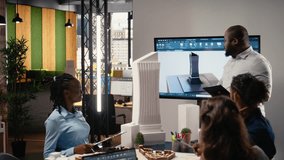 Urban development diverse team discussing property investment new strategy for project approval in a bright office setting, analyzing blueprints and 3D models on architectural software. Camera A. - Powered by Shutterstock - Get 15% off with code: PIKWIZARD15