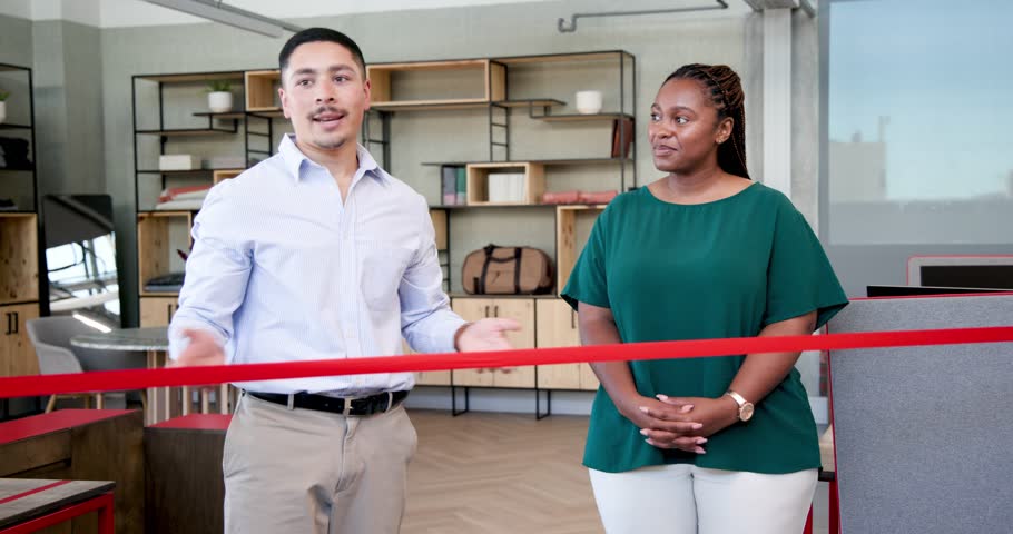 African American woman and Diverse man cutting red ribbon in modern office interior with scissors. Celebration, teamwork, achievement, success, entrepreneurship, event, office