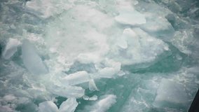 Churning turquoise waters jostle fractured ice sheets and floating slabs, capturing the breakup of river ice as jagged floes collide and swirl in powerful currents. - Powered by Shutterstock - Get 15% off with code: PIKWIZARD15