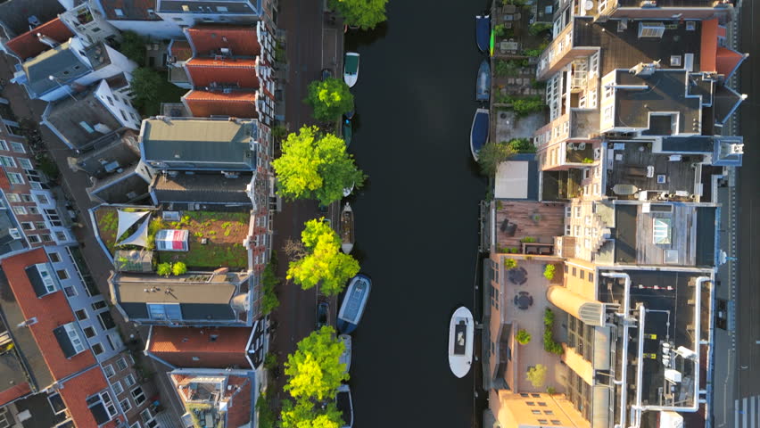 Explore Amsterdam stunning canals and historic architecture from above. The lush greenery enhances the beautiful waterways, creating a picturesque and tranquil setting for relaxation and discovery