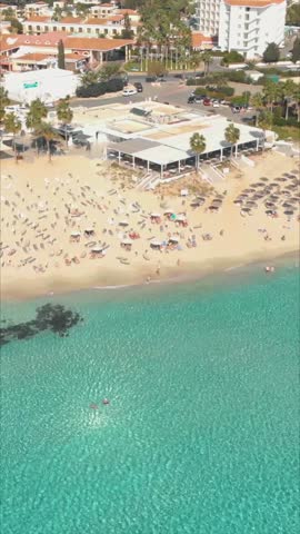 Drone vertical shot of Nissi Beach with golden sand and clear waters in Cyprus