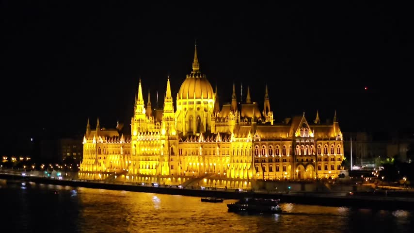Hungarian Parliament Building Illuminated at Night with Boats on the Danube - Budapest, Hungary
