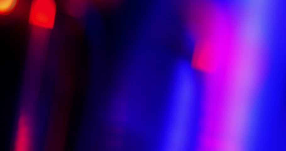 Seamless Loop Light leak background. Vibrant Prism Light Streaks in Motion. Video capturing dynamic streaks of blue, purple, pink, and red lights - real effect.	