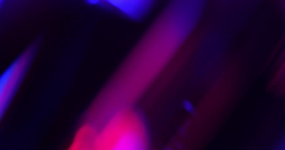 Light leak background. Vibrant Prism Light Streaks in Motion. Video capturing dynamic streaks of blue, purple, pink, and red lights - real effect.	