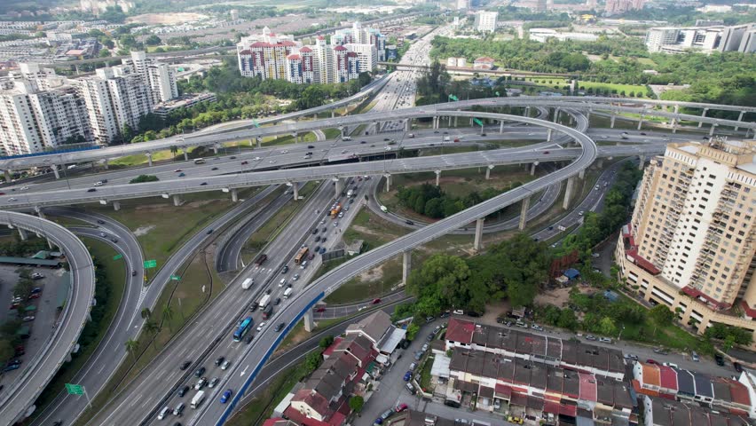 Busy streets on a highway intersection at Sri Petaling in Kuala Lumpur, Malaysia, busy streets and traffic jams on a lovely day. Result of great infrastructure investment in this asian megacity