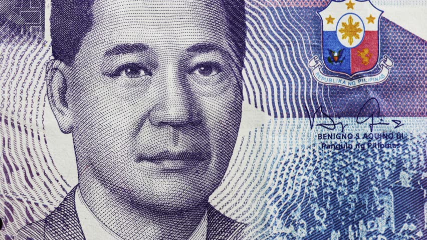 Close pan across Philippine peso banknote portrait with Filipino Latin script