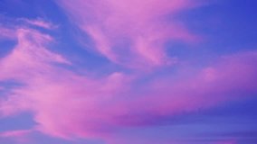 Vibrant pink hues dominate the clouds as they drift across a canvas of deep blue, creating a breathtaking spectacle of color and light in the twilight sky - Powered by Shutterstock - Get 15% off with code: PIKWIZARD15