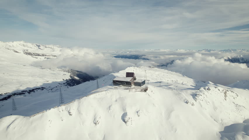 Flying towards a ski lift station in the Swiss alps, Laax, Switzerland