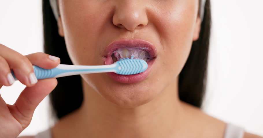 Toothpaste, oral care and mouth of woman in studio for grooming, wellness or hygiene with toothbrush. Dental health, morning and female person brushing teeth for fresh breath by white background.