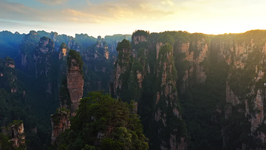 Majestic Zhangjiajie national forest park: towering sandstone pillars and green forest at sunset, Wulingyuan Scenic Area, Hunan Province, China.