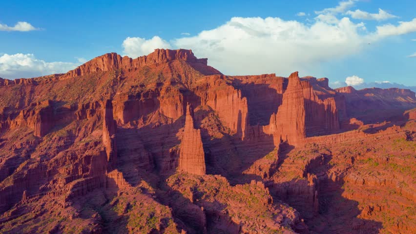 Time-lapse of the Fisher Tower with clouds moving behind a clear blue sky, highlighting architectural details and dynamic sky movement. Perfect for travel visuals, architecture projects, cityscapes