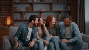 Multiethnic four friends jumping running falling on couch at home party giving high five laughing smiling diversity group of best buddies gathering together men women on sofa having fun fooling unity - Powered by Shutterstock - Get 15% off with code: PIKWIZARD15