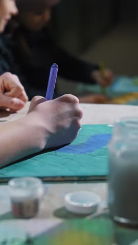 War in Ukraine. Bomb shelter. Children are hiding in shelter in the basement, during an air alert, rocket fire. They are drawing. Russian invasion. Stop war. No War.