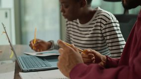 Arabian businessman African American businesswoman looking in laptop talking writing in office informal business team two diversity managers multiethnic partners planning financial economic strategy - Powered by Shutterstock - Get 15% off with code: PIKWIZARD15