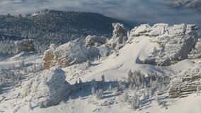 Morning sun glides across snowbound tors above the taiga in Sheregesh, Russia. The camera sweeps over frosted pine and red sandstone, revealing a calm cloud sea beyond the ridge in winter - Powered by Shutterstock - Get 15% off with code: PIKWIZARD15