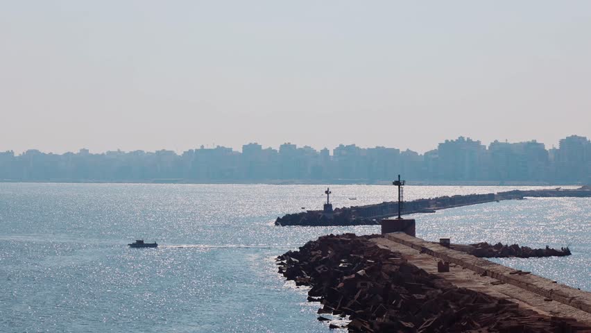 Panoramic view of Alexandria, Mediterranean Sea and floating fishing boats along shore, Egypt, shot handheld. High quality 4k footage