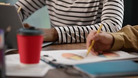 Asian man Korean businessman reading documents diagram with African business woman American businesswoman working in informal office team with laptop thinking pensive solution teamwork multiracial job - Powered by Shutterstock - Get 15% off with code: PIKWIZARD15