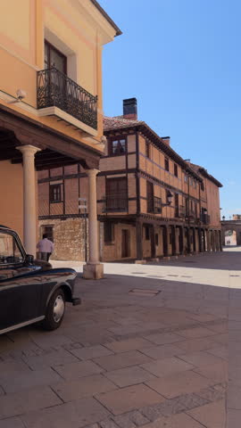 Black vintage taxi parked in Plaza Mayor, El Burgo de Osma, Spain, with traditional Castilian architecture