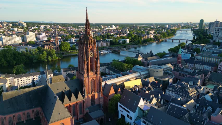 4K Drone Video of the Gothic-Style Kaiserdom St. Bartholomäus Cathedral and Evangelische Dreikönigskirche Church on the Main River in Downtown Frankfurt, Germany