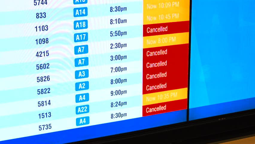 Departure board continuously updating delayed and cancelled flights, highlighting airline schedule changes, passenger inconvenience, weather impacts, and the unpredictable nature of modern air travel.