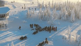 Aerial view of a snowmobile briefing by frosted spruce on the Sheregesh plateau, riders gather as skiers pass and tracks weave between trees. Cold blue light and hoarfrost create a bright winter scene - Powered by Shutterstock - Get 15% off with code: PIKWIZARD15