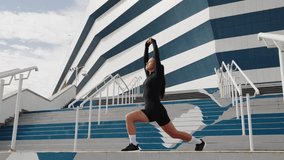 Female athlete engages in a dynamic stretching routine in front of a modern stadium, showcasing strength and determination - Powered by Shutterstock - Get 15% off with code: PIKWIZARD15