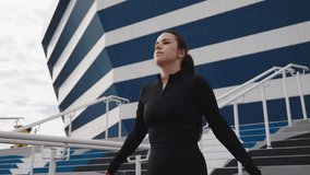 Female athlete engages in a series of warm-up stretches, demonstrating focus and determination against a striking stadium backdrop - Powered by Shutterstock - Get 15% off with code: PIKWIZARD15