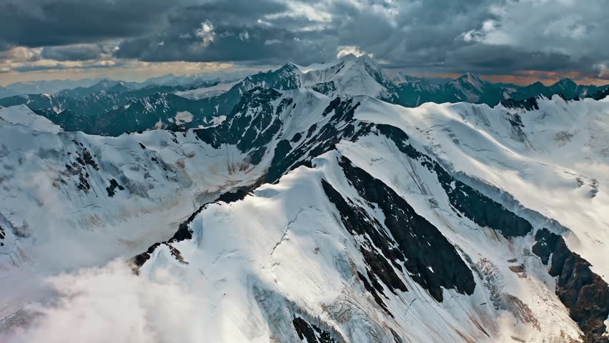 Majestic snow capped mountain peaks glacier valleys dramatic cloudscape aerial view breathtaking landscape stunning panorama high altitude wilderness adventure exploration remote region