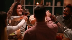 Multigenerational friends sharing laughter, raising wine glasses, enjoying traditional thanksgiving feast with warmth and gratitude around festive candlelit dinner table - Powered by Shutterstock - Get 15% off with code: PIKWIZARD15