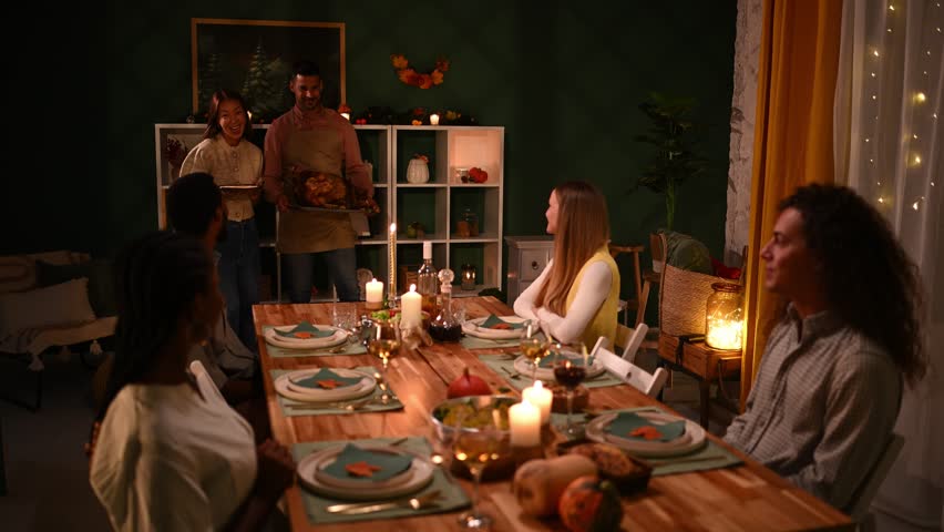 Friends enjoying hearty thanksgiving meal, warmly gathered around table, sharing roasted turkey while celebrating close connections and seasonal traditions