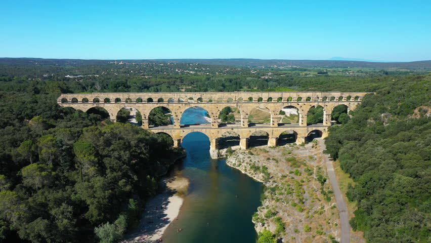 The Pont du Gard is an ancient Roman aqueduct, that is depicted  on five euro note. Summertime.