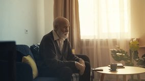 Upset elderly man looking at mobile phone, waiting for a call from his children - Powered by Shutterstock - Get 15% off with code: PIKWIZARD15